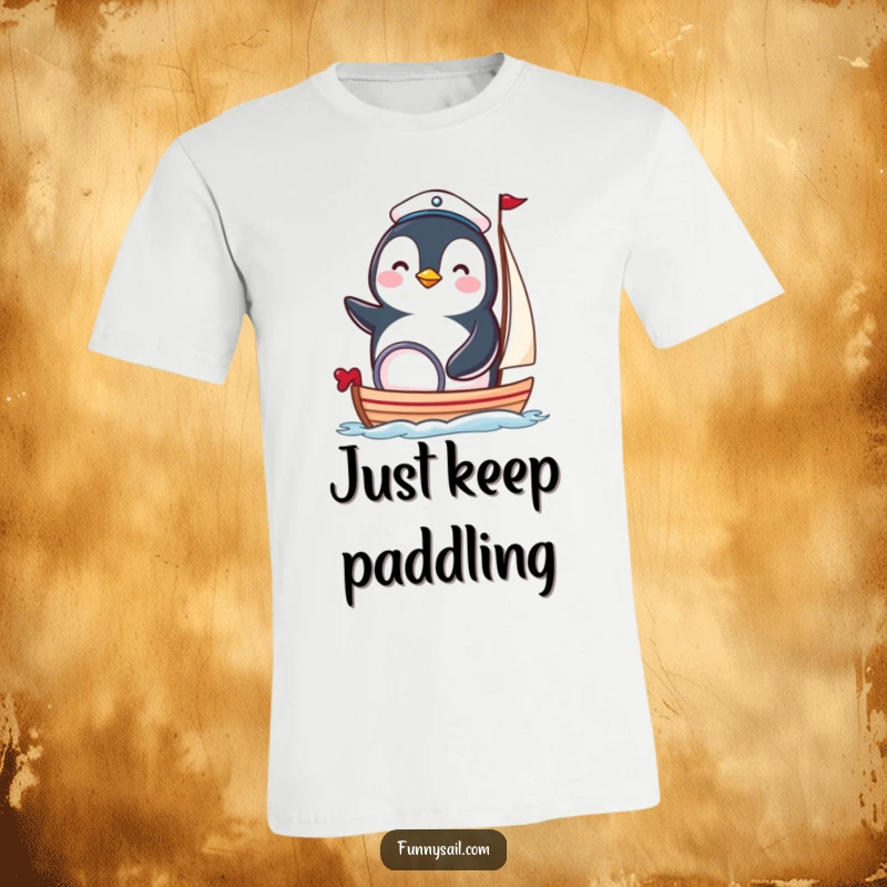 Funny penguin sailor t-shirt showing a happy bird in a sailor hat steering a tiny boat, perfect for sea lovers.