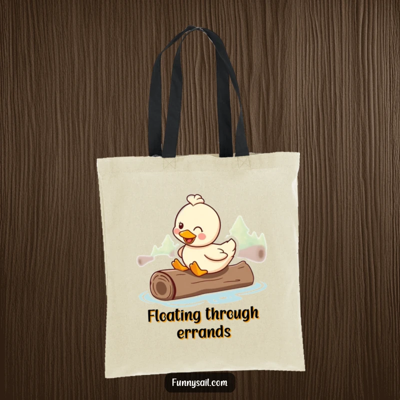 Funny tote bag showcasing a happy duck smiling while riding on a floating log, ready for any adventure.